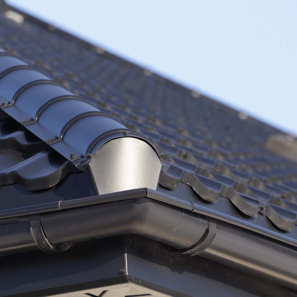 Corner of the house with gutter on sunny day.