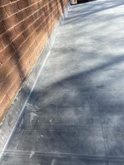 EPDM Rubber Roofing with edging to house wall